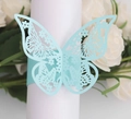 Macro shot of light blue laser-cut butterfly napkin ring on a white table setting - Pearl Pale Blue
