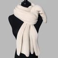 Macro view of thick knit texture on this warm cream white winter scarf for women and men - Beige