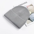 Classic grey cuffed knit beanie hat with thick texture shown with props - Heather Grey