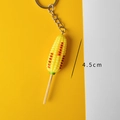 Realistic roasted corn keychain with textured yellow resin finish and silver metal ring - Corn Skewer