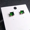 Detail of emerald green square stud earrings with four-prong silver setting - Green Stone Rose Gold