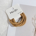 Detail showing set of brown high-elasticity hair bands on minimalist paper card - Yellow
