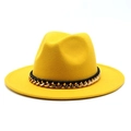 Macro view of bright yellow wool fedora hat with black leather band and gold metal chain - Yellow