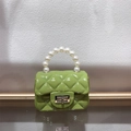 Detail of green mini jelly bag featuring pearl handle, metal lock, and quilted texture - Olive Green
