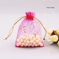 Close-up of hot pink organza jewelry pouch with gold star and moon prints and drawstring - 7*9cm / Rose Red