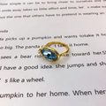 Golden ring with oval blue gemstone and small clear stone accent on white paper background - US 6 / Royal Blue