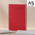 Red A5 faux leather office notebook with magnetic buckle on a creative office desk - A5 Red Nubuck Leather