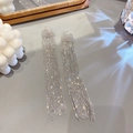 Detail view of silver long fringe tassel earrings with shimmering crystals on textured background - Silver Row Diamond Tassel (Silver Earring Post)