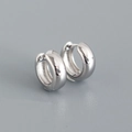 Detailed macro view of high-polished S925 sterling silver round hoop earrings with snap closure - 925 Silver / White Gold