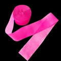 Pink crepe paper streamer roll for wedding and party decorations on black background - Fluorescent Rose