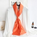 Elegant narrow orange silk scarf tied on a white shirt with fashionable accessories - Orange