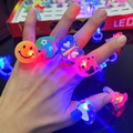 LED glowing rings in various shapes like heart and butterfly worn on a hand - Cartoon Soft Rubber Ring Lamp