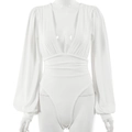 Detailed view of white long sleeve deep V-neck bodysuit with puff sleeves and waist pleats - White