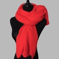 Detailed close-up of a red chunky knit winter scarf on a mannequin torso with visible texture - Red