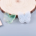 Detail of butterfly silicone mold for resin casting with a glittery green finished pendant - Butterfly Shape Quicksand Mold
