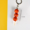 Realistic grilled meatball skewer keychain in caramel orange finish, 5.2cm length - Fried Meatball Skewer