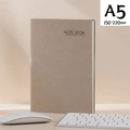A5 executive notebook in warm brown leather finish with buckle on office desk setup - A5 Beige Nubuck Leather