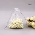 Detailed shot of white organza jewelry bags with silver foil stars and moon patterns - White Silver