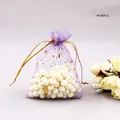Detail of purple organza gift bag with gold star and moon foil print and drawstring - Purple