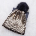 Metallic gold knit beanie with black faux fur pom pom on white fur background - Gold with Pom-pom