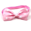 Close-up of pink polka dot pet bowtie accessory with ribbed fabric texture on white background - Pink with White Dots