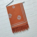 Orange cashmere-style scarf with white daisy jacquard pattern and fringes on a hanger - Daisy Orange