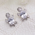 Silver sea turtle stud earrings with white zircon crystals on a textured fabric surface - White Gold With White Zirconia