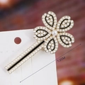 Detail of 7.2cm clover pearl hair clip with gold alloy base and black enamel inlay - S192-11 Pearl Clover Hair Clip