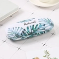 Portable white eyeglasses case with green monstera leaf print and Natural text - Broad Banana Leaf
