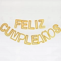 Macro detail of gold glitter Feliz Cumpleaños Spanish birthday party banner on white wall - Hollow Spanish Birthday Glitter