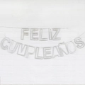 Sparkling silver glitter Feliz Cumpleaños Spanish birthday banner hanging on a white wall - Hollow Spanish Birthday Glitter Silver