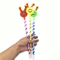 Three colorful plastic party blowouts with smile face emoji designs in red, yellow, and green - Large Smile Face Blowout