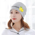 Detailed close-up of a grey knit maternity hat with Monstyle lettering and lemon pattern - Lemon / Gray