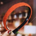 Detail view of orange plush wavy headband with internal teeth showing 15.5cm size - Orange (Plush)