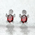 Macro shot of silver turtle stud earrings with a large red oval zircon and white crystals - Platinum Plated Red Zirconia
