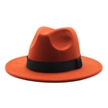 Detail of orange wool fedora hat featuring a stylish black decorative band and flat brim - Rust red