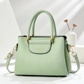 Detail of mint green lychee pattern leather handbag with golden hardware and dual handles - L24.5xW12xH18.5cm / Green