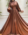 Detail of metallic bronze pleated maxi dress showing waist cinching and long puff sleeves - S / Brown