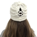 Close-up of white knitted beanie with criss-cross cutout for high ponytail hairstyle - One Size / White