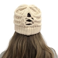 Detail of cross-straps on cream knit beanie designed for ponytails and buns - One Size / Beige