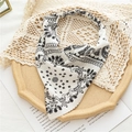 Close-up of a white paisley patterned bandana headband on a vintage wooden tray - White