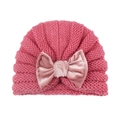 Rose pink knit baby beanie hat with a velvet bow decoration on a white background - Dusky Pink