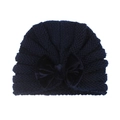Detailed view of dark navy knit baby beanie with large velvet bow decoration - Navy Blue