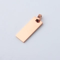 Macro detail of polished rose gold rectangle pendant with smooth reflective surface - 10*25mm / Rose Gold
