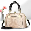 Elegant beige crocodile-pattern handbag with black handles and crystal clasp detail - Apricot