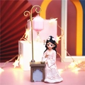 Pink traditional Chinese doll figurine with desk and lantern on a warm background - Chess-Playing Princess with Lamp (25B)