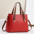Red lychee pattern leather Boston handbag with brown handles and gold hardware accents - Red