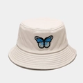 Close-up of blue butterfly embroidery on beige cotton bucket hat with parallel stitching - Beige