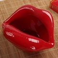 Vibrant red ceramic lip-shaped ashtray with smooth glazed finish on bamboo mat - Style A / Burgundy