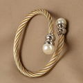 Detail of twisted gold and silver steel wire bracelet with elegant white pearls - Two-Tone Cable/Steel Ends